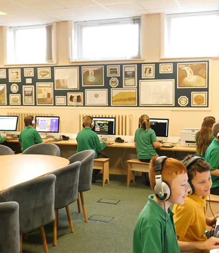 A classroom of young people using computers